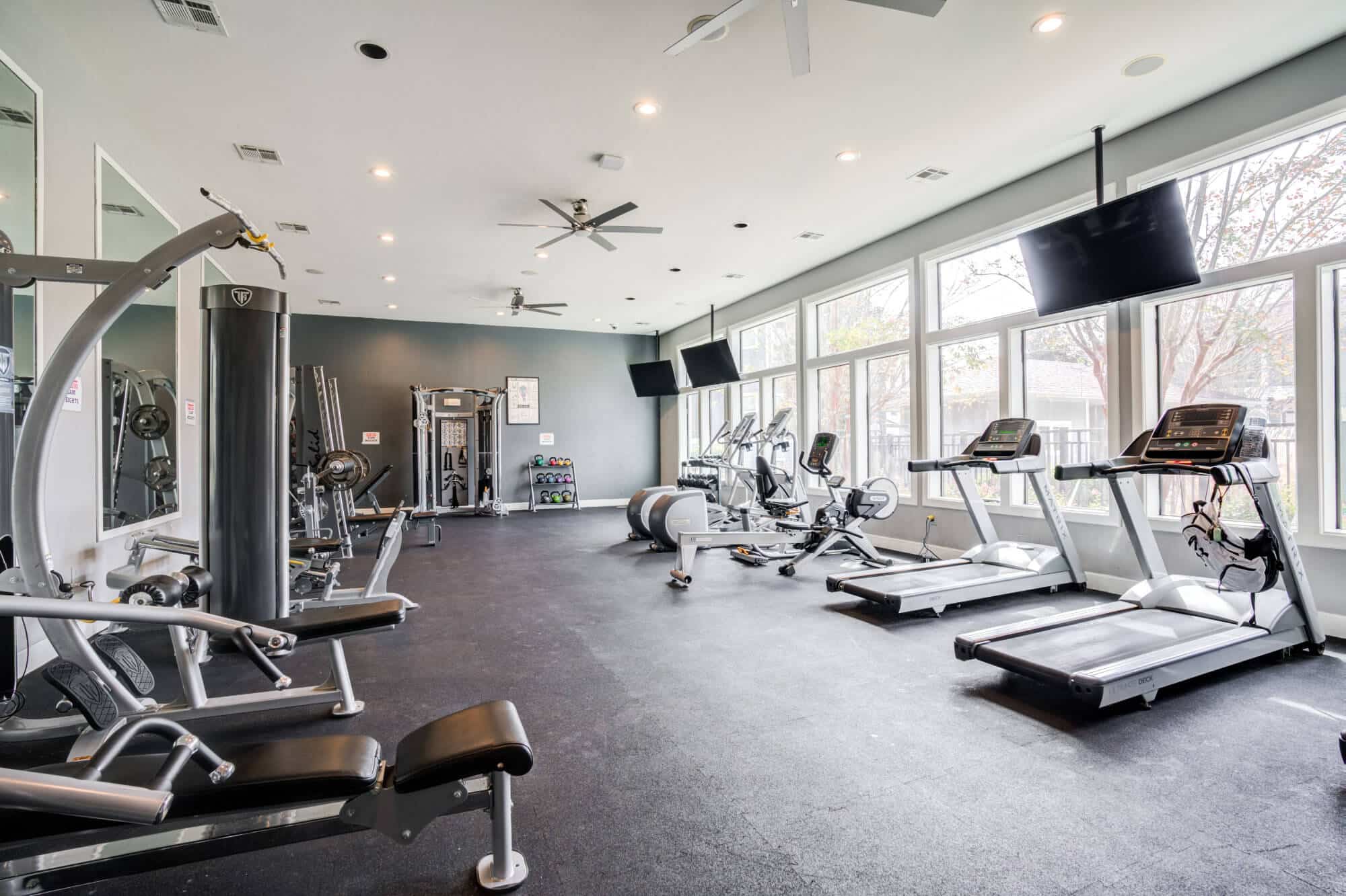 Modern gym with various exercise equipment.