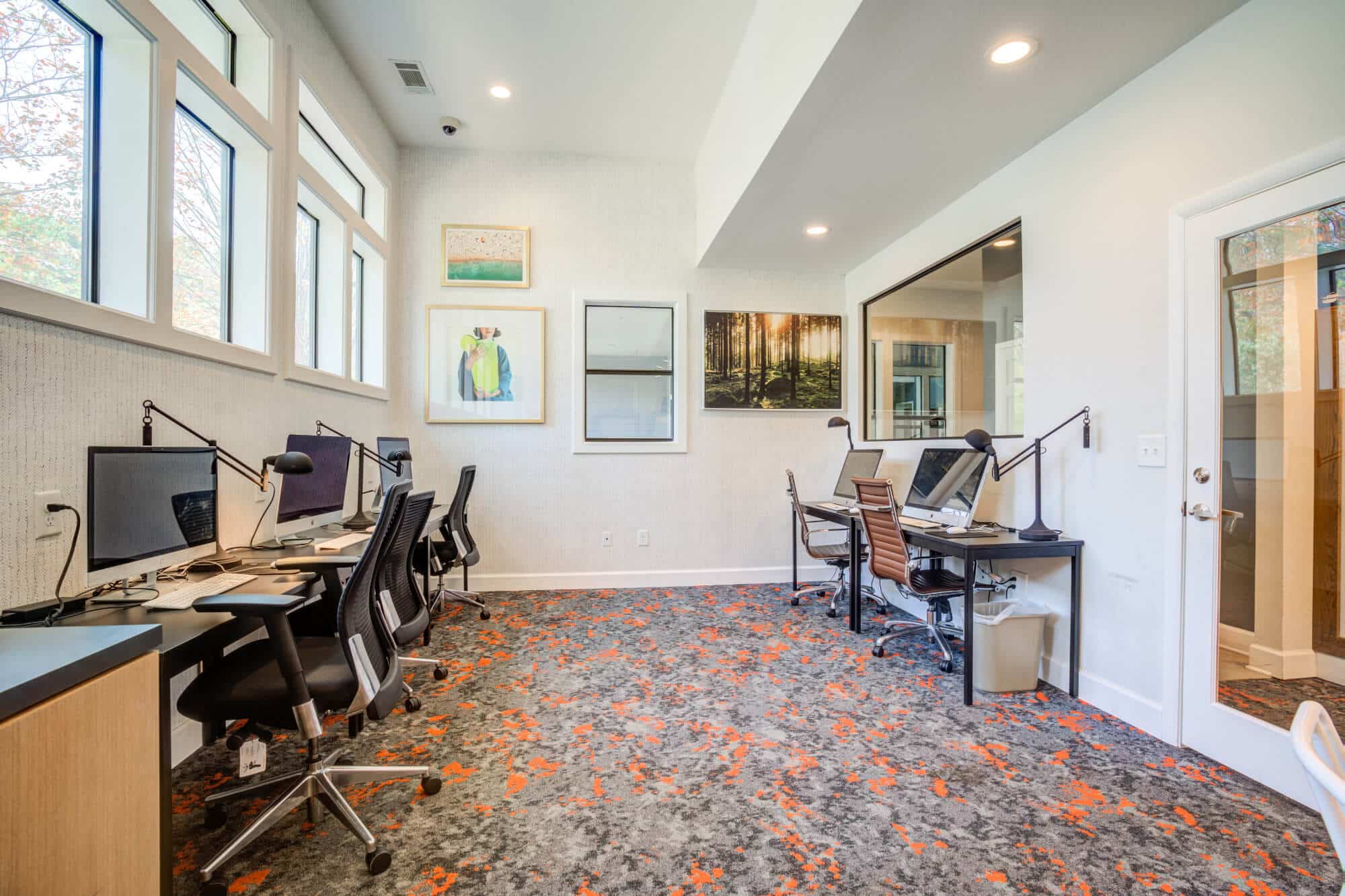 Modern workspace with computers and chairs.