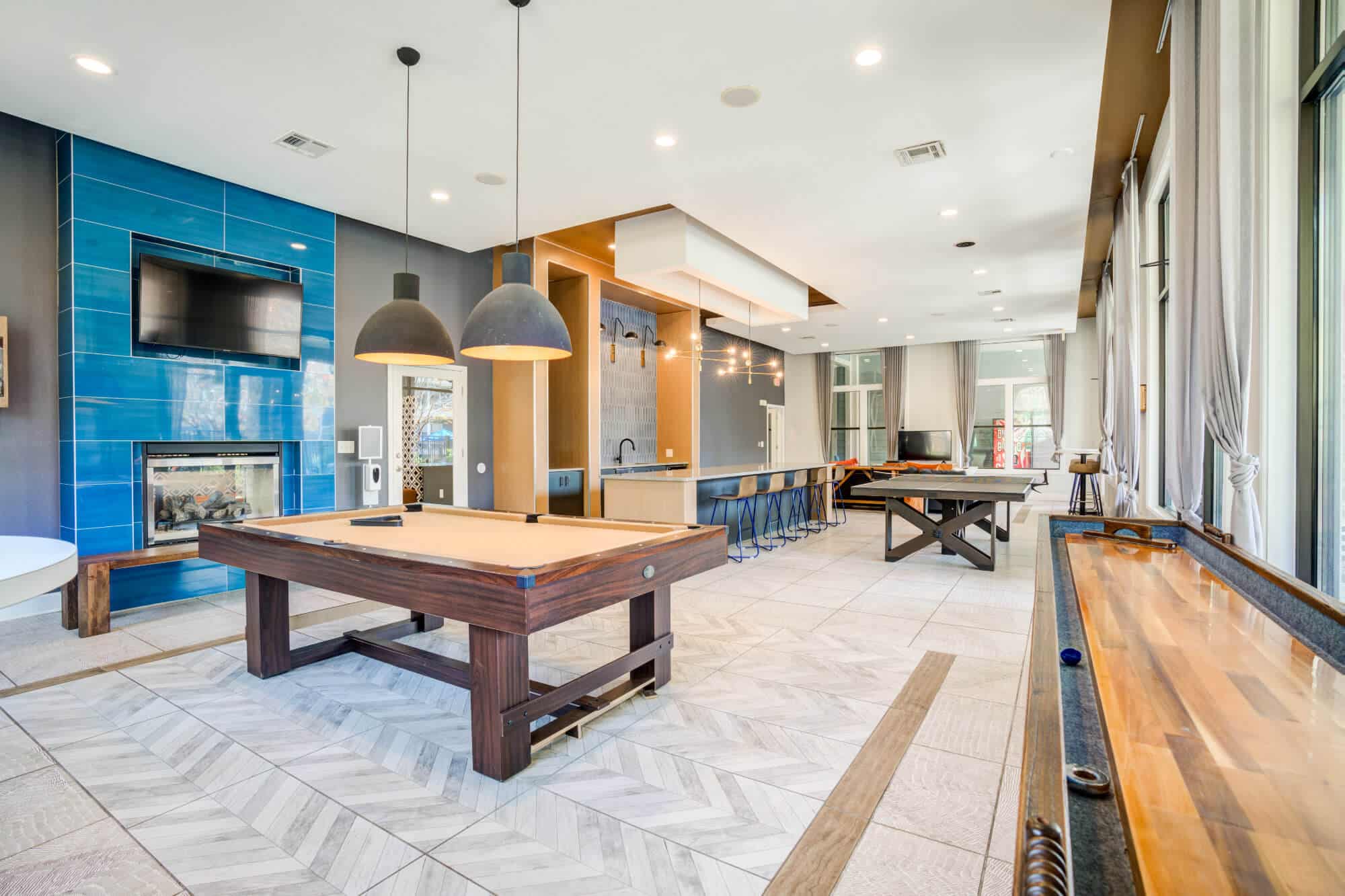 Modern game room with various tables.