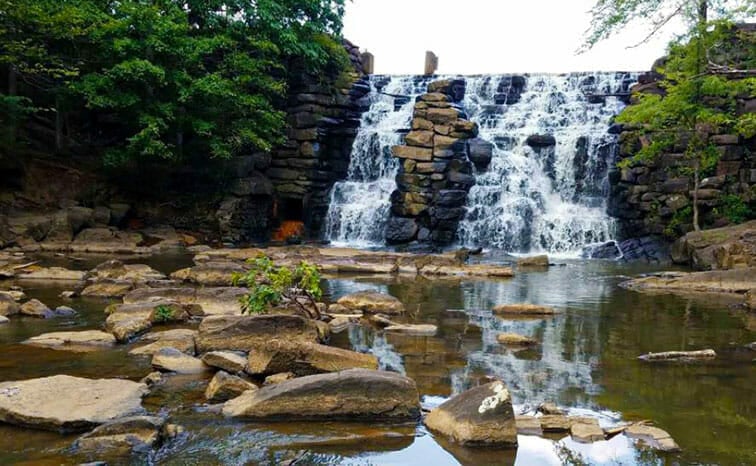 Waterfall cascading over rocky landscape.